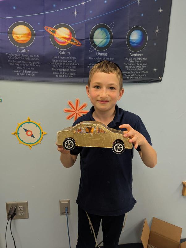 A student displays their car that they made