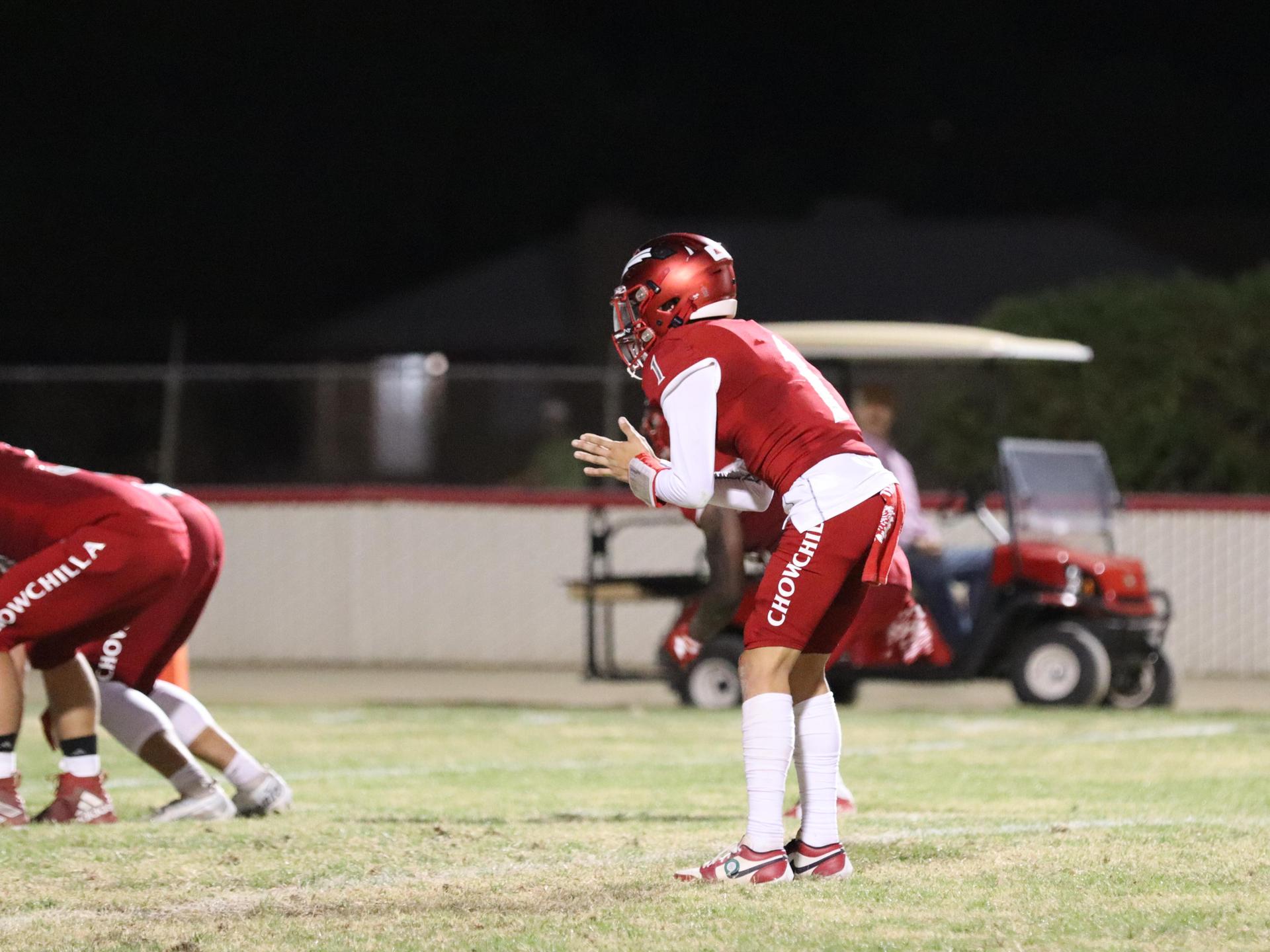 varsity football players in action against Riverdale