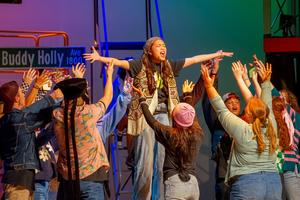 Ensemble from Godspell circles around one student that is belting.