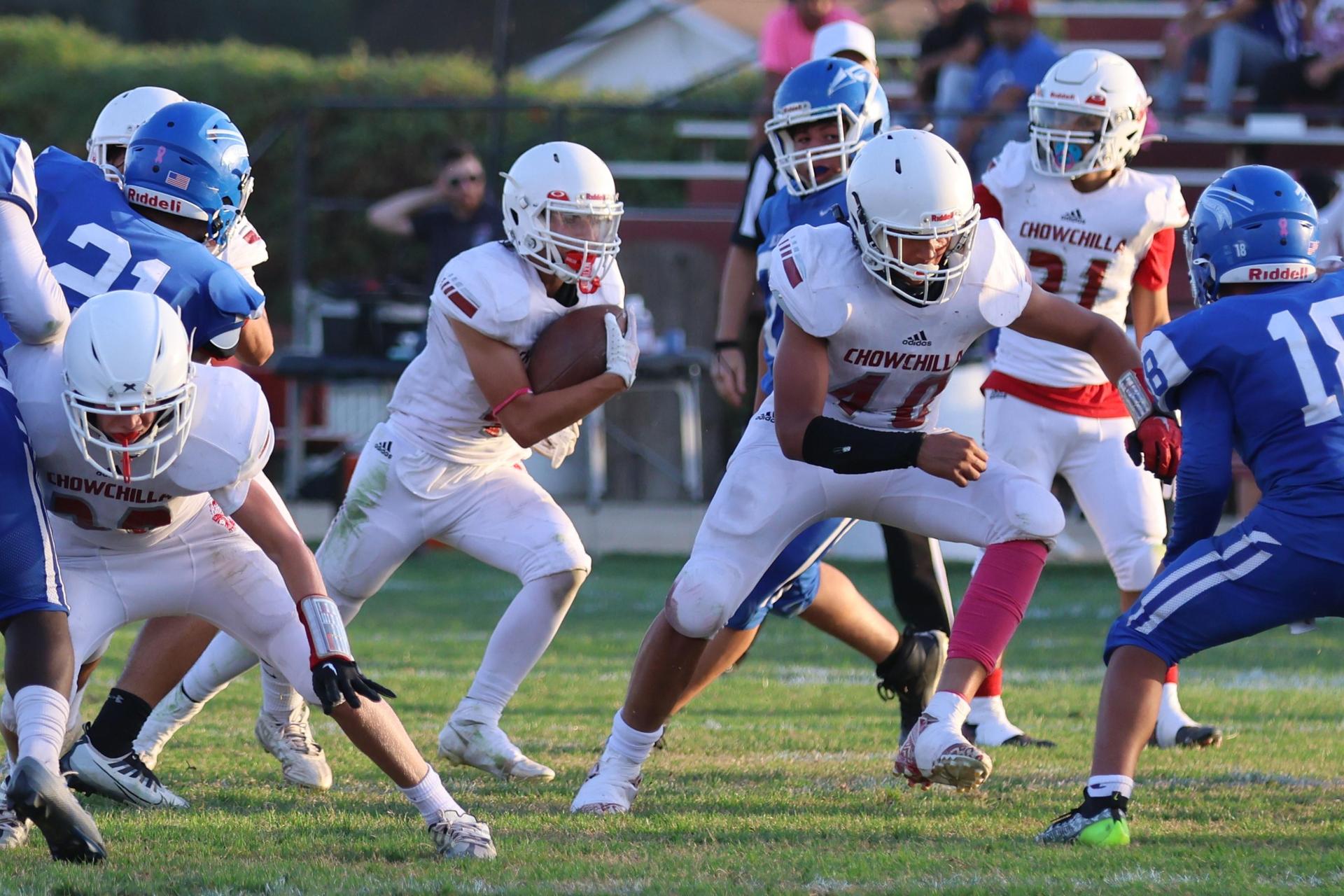 Junior Varsity football players in action against Caruthers