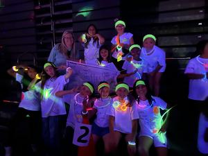 Students at the glow in the dark fun run wearing glow sticks.
