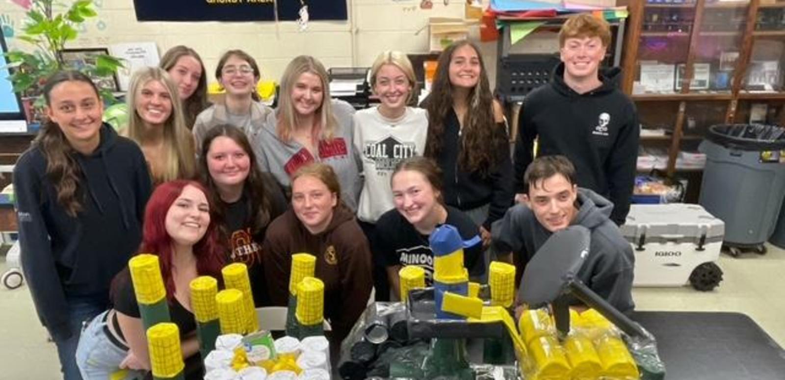 Agriculture students stand behind their tractor display.