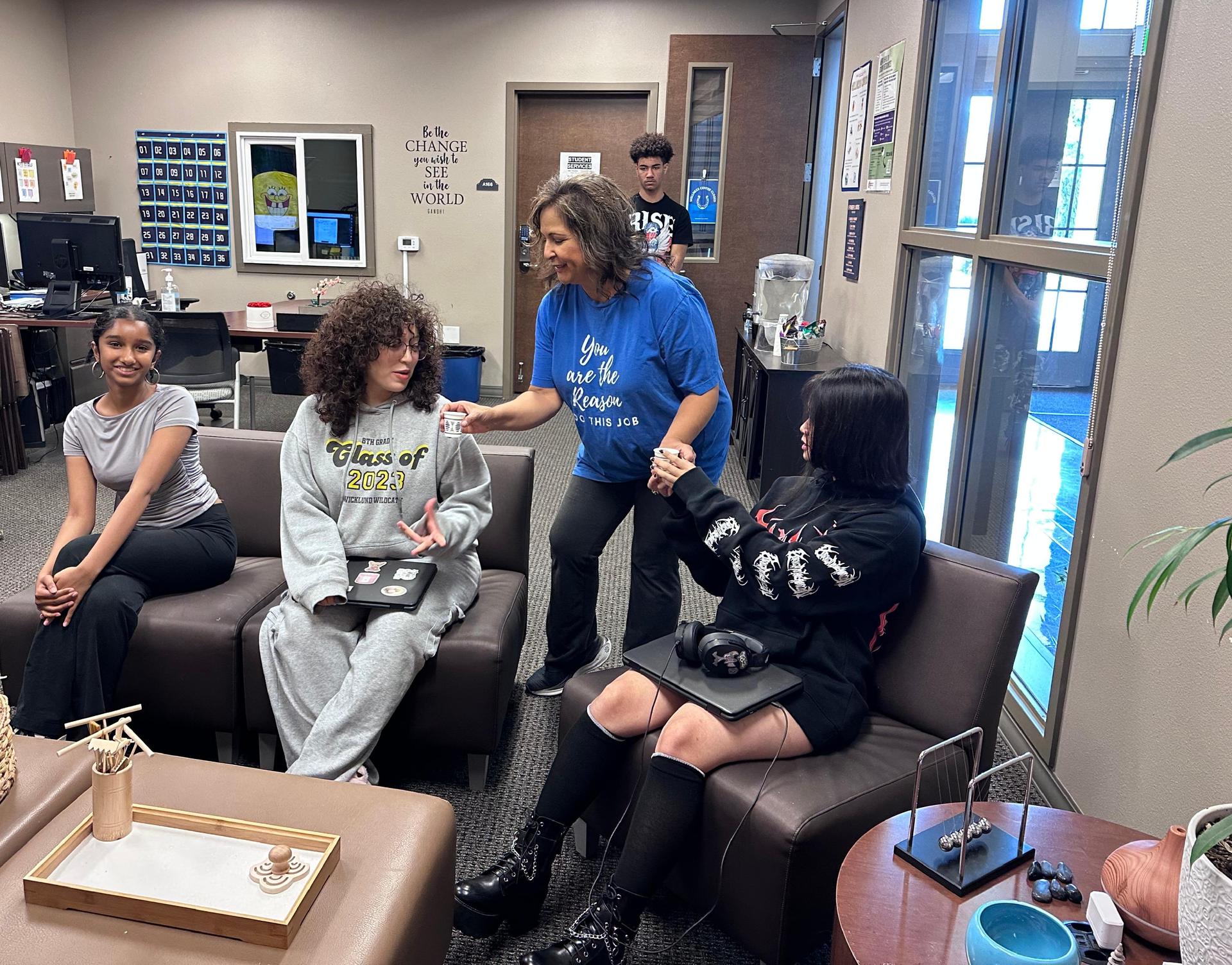 three students with one staff member in the wellness center