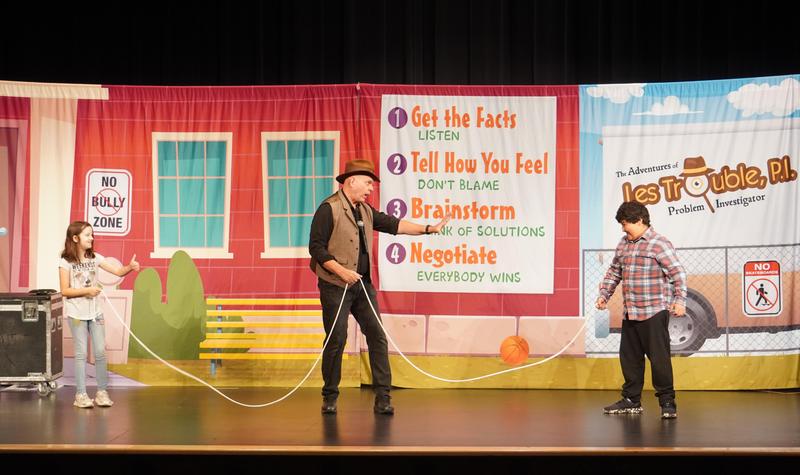 Two students hold a rope as if they are going to have a tug-o-war.