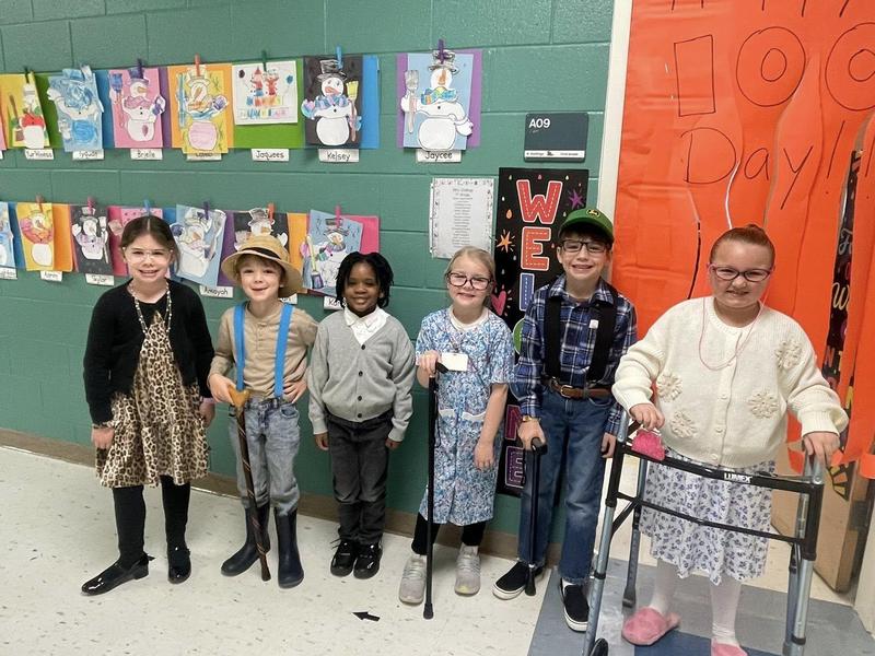 PCMS student showing a PCS student their Chromebook.