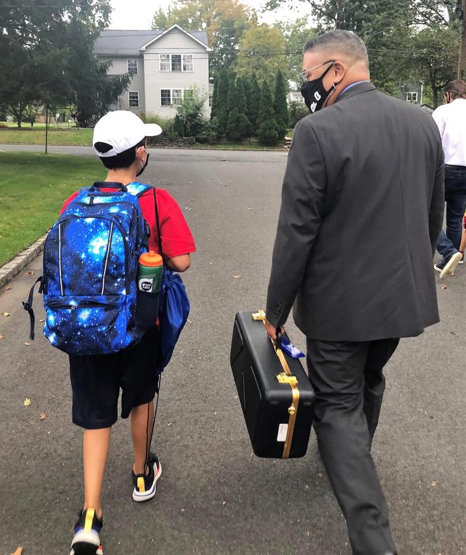 Westfield Superintendent Dr. Raymond González escorts Jefferson 4th grader Owen Hennes to school in celebration of Walk to School Day on Oct. 6.