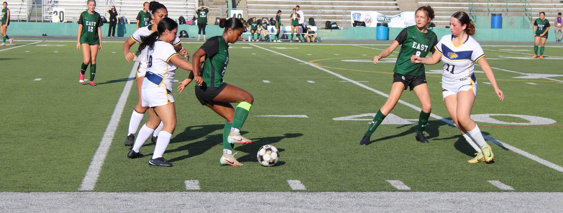 CHSE girls soccer have possession of the ball as they run on the field.