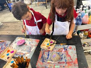 TK Student exploring in Art wearing Painter Smocks