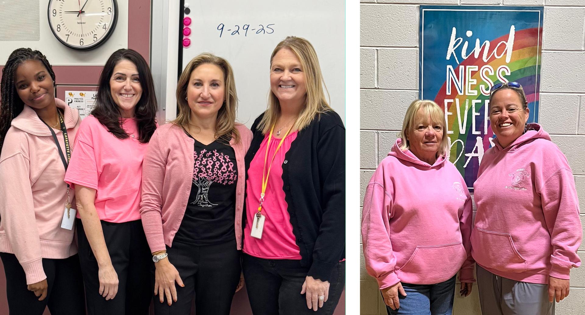 Four women wearing pink attire next to a whiteboard and a colorful kindness poster.