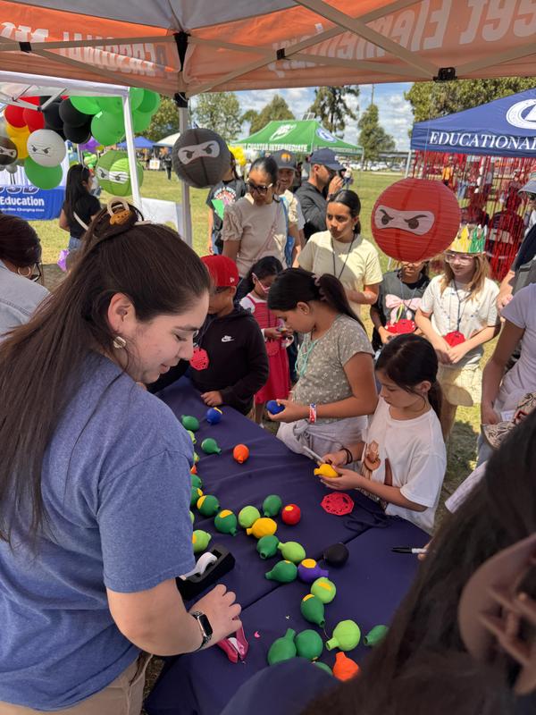 Ms. Miranda helping students with crafts