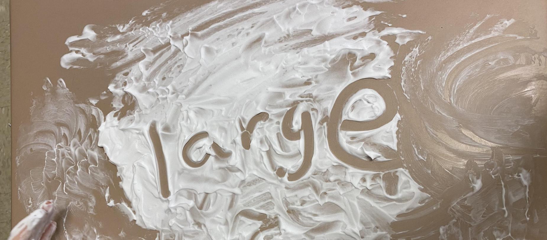 the word 'large' written in shaving cream