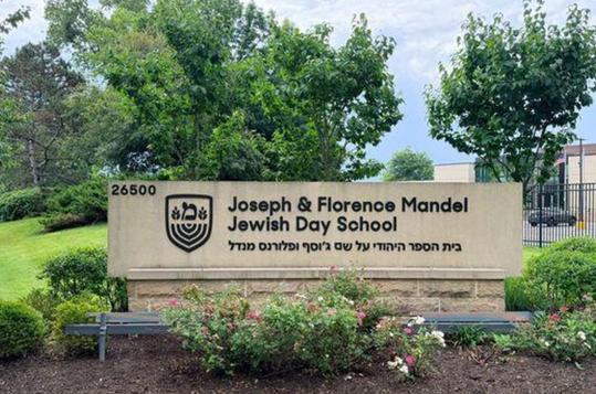 Sign for Joseph & Florence Mandel Jewish Day School in a landscaped area.
