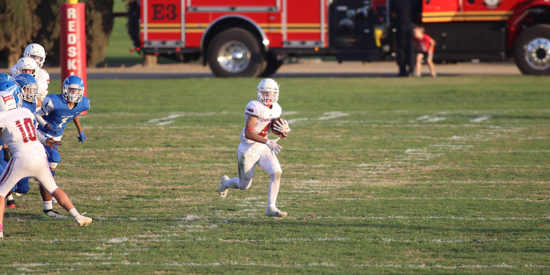 Junior Varsity football players in action against Caruthers