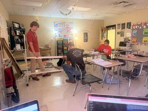 Carson, Vance, and Mackensy assembling the white board.