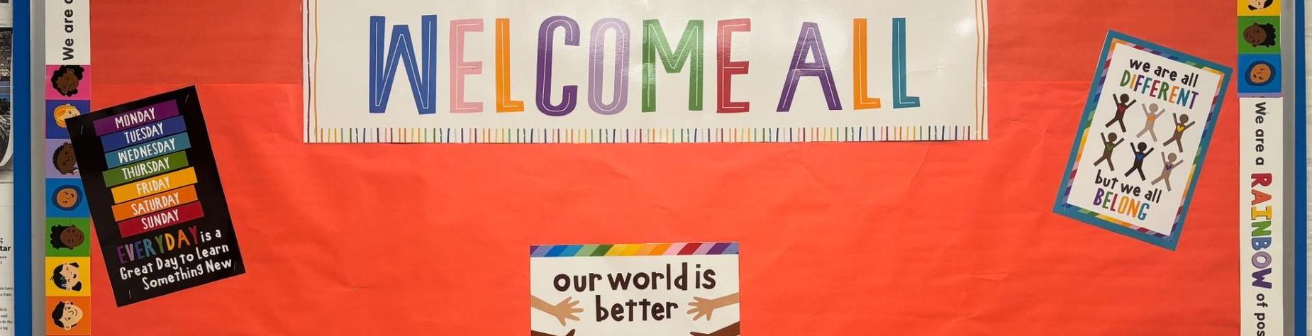 Colorful bulletin board promoting inclusivity with a globe and diverse handprints.