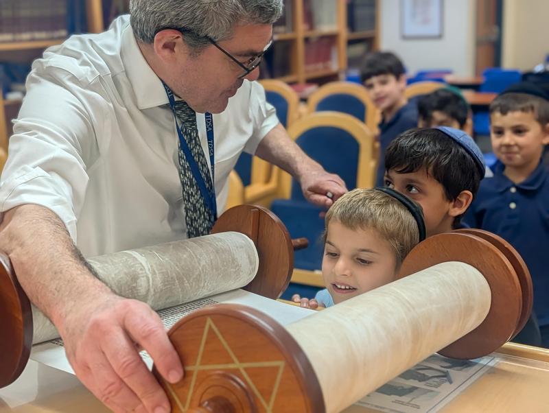 Boy looking at torah