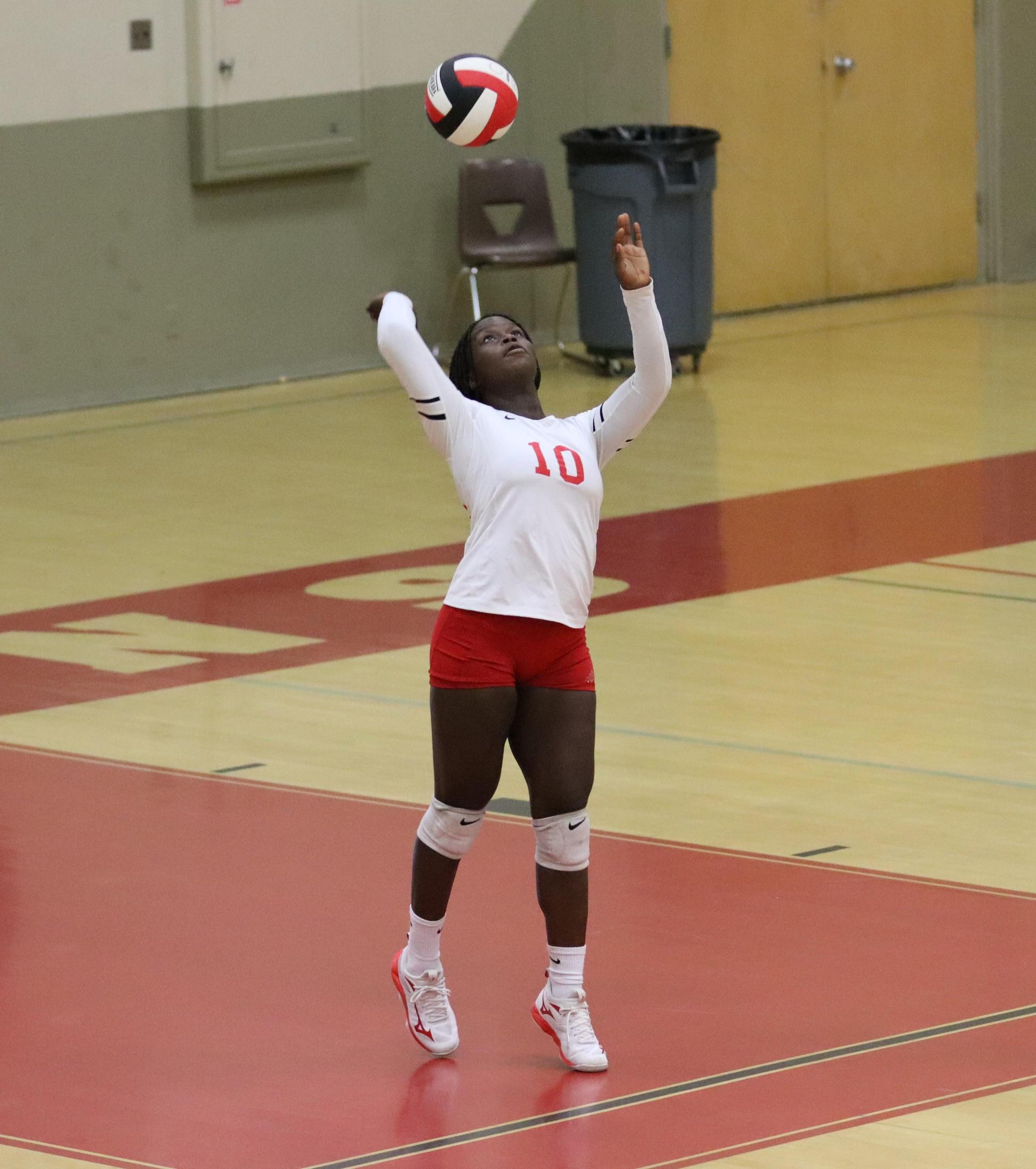 varsity volleyball players in action against liberty