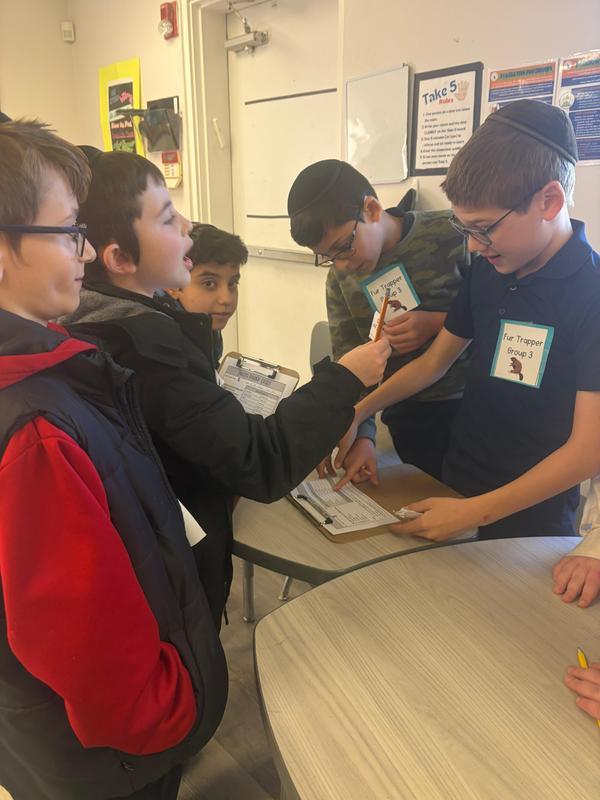 Fifth grade boys practice bartering skills.