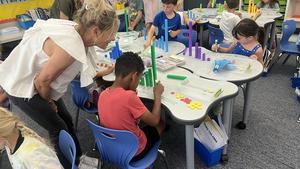 Classroom teacher talking to student