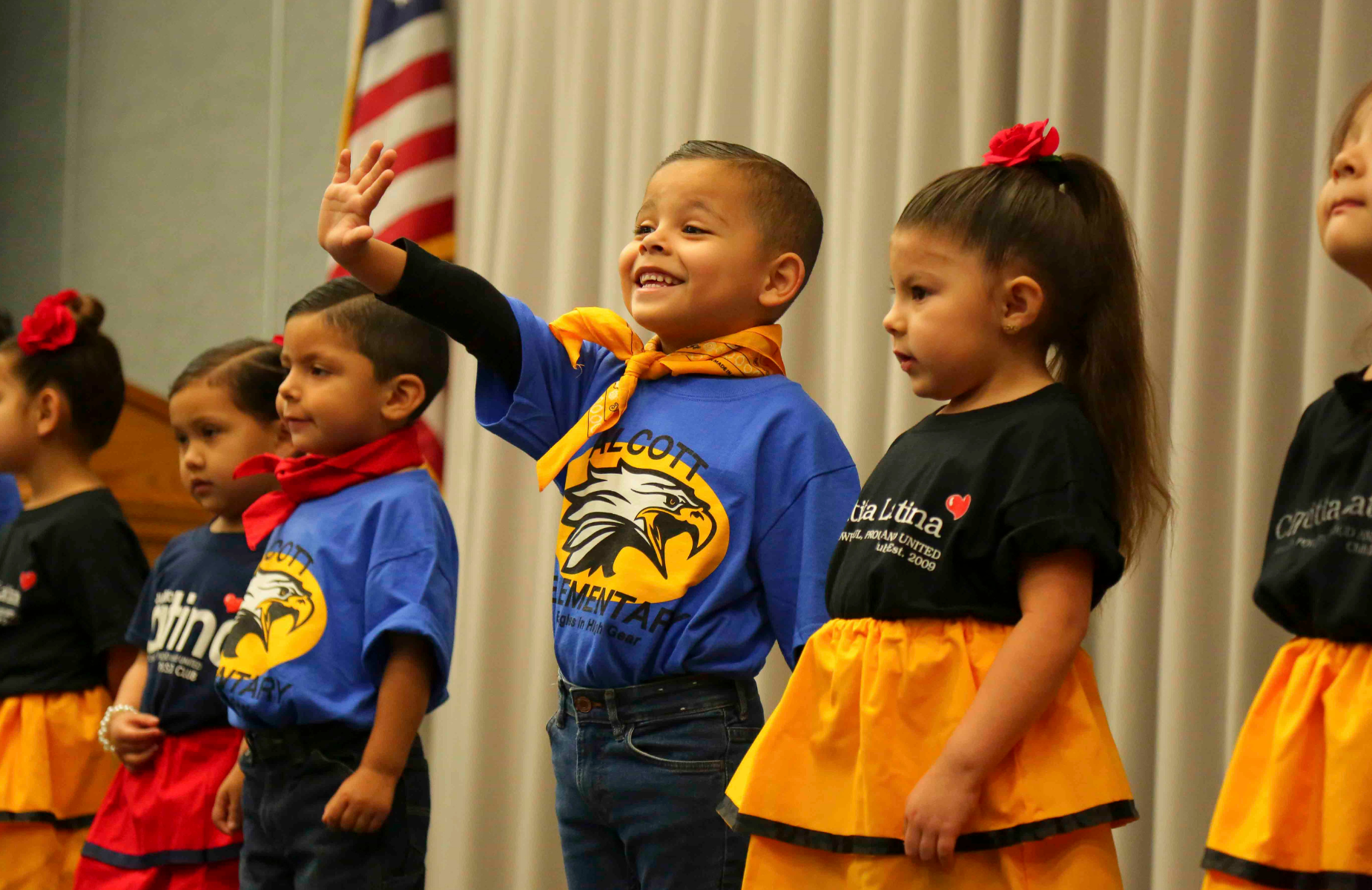 Shuffle banner for district homepage - infographic of students at a celebration for Latina/Latino group dance