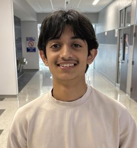 Aryan Guleria stands in the hallway at Temple HS