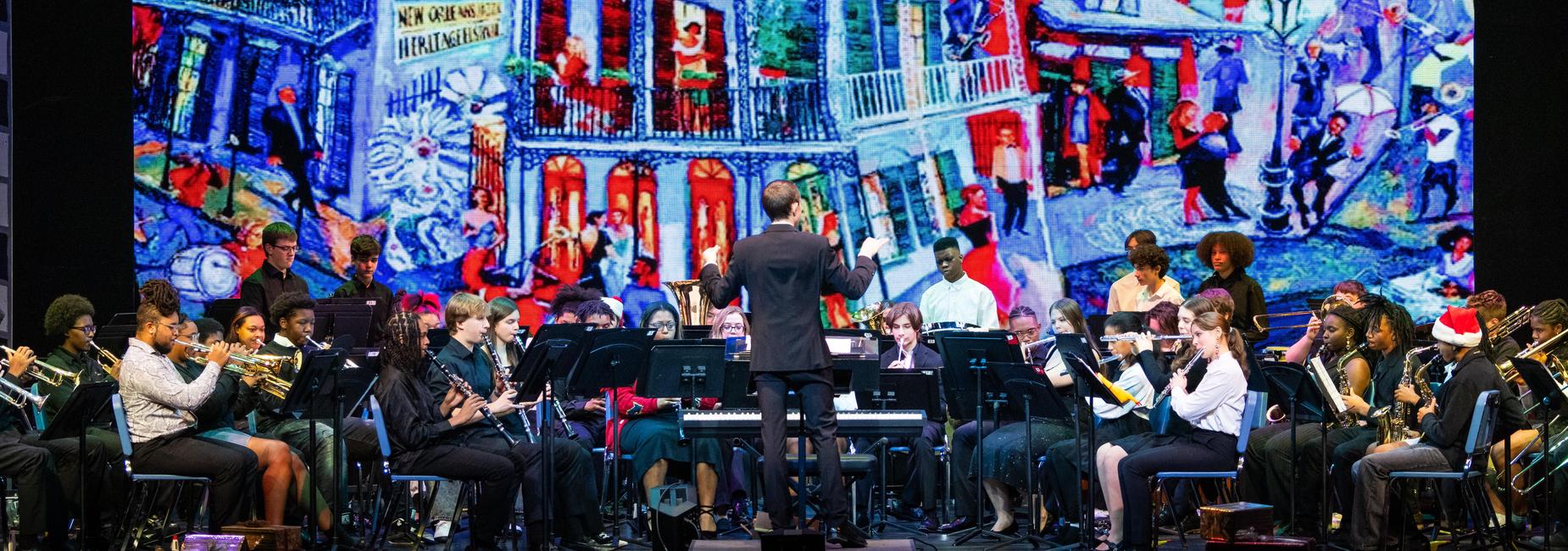 The concert band performs on stage