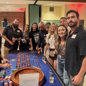 A group of parents around a poker table