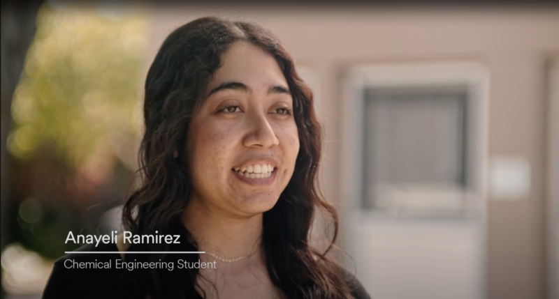 A young woman identified as “Anayeli Ramirez, Chemical Engineering Student” smiles as she speaks in an interview-style setting. The background is softly blurred, drawing attention to her expression and title.
