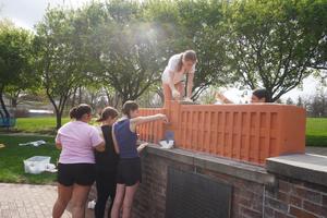 Students paint part of the Spirit Park sculpture.