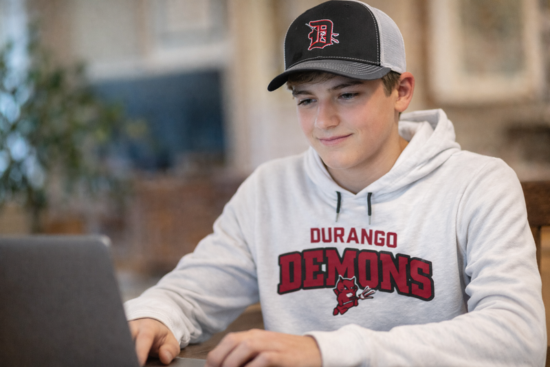 Student focused on computer at home
