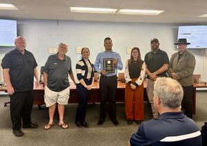 The school board presents Employee of the Month awards.