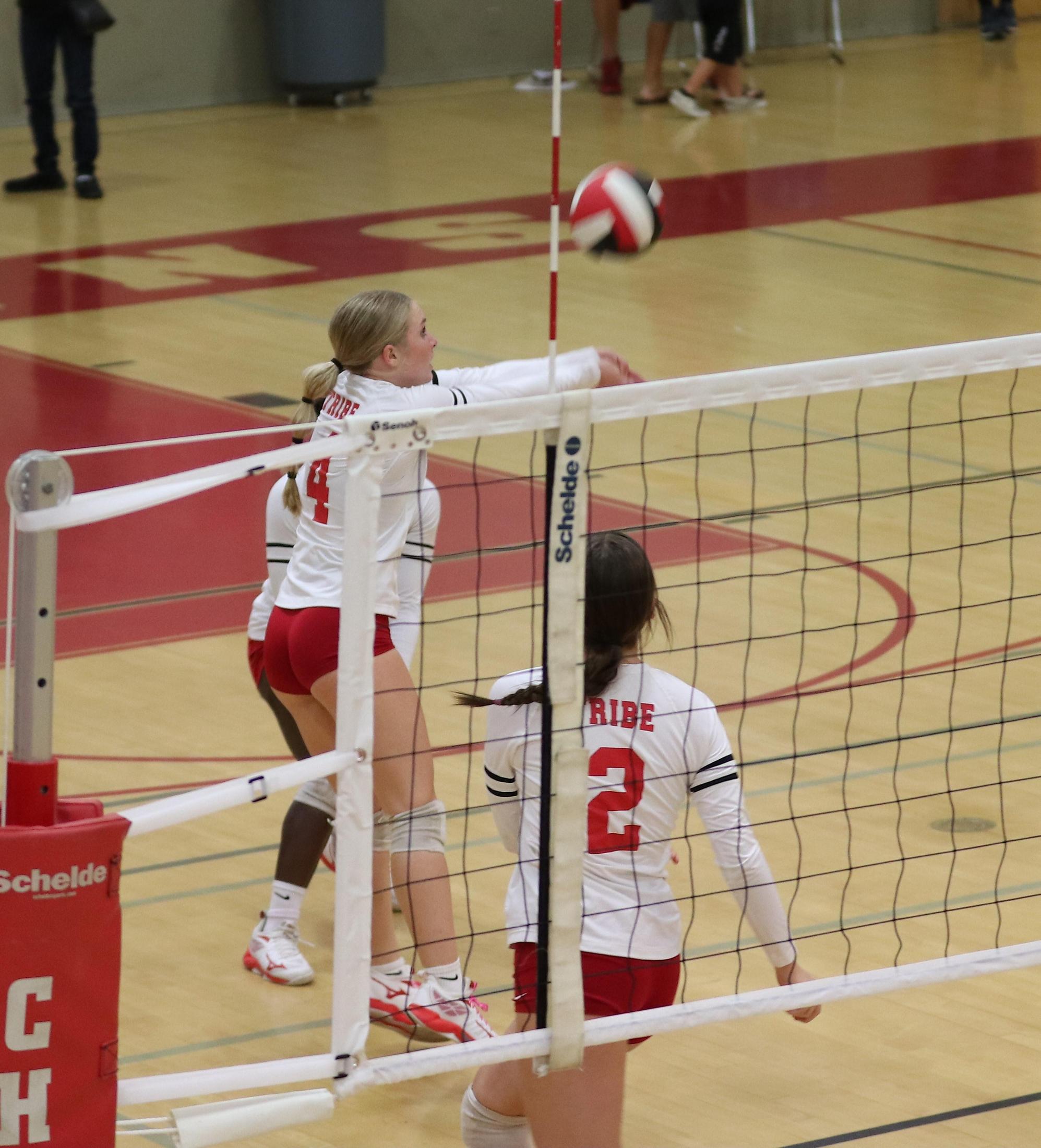 varsity volleyball players in action against Minarets