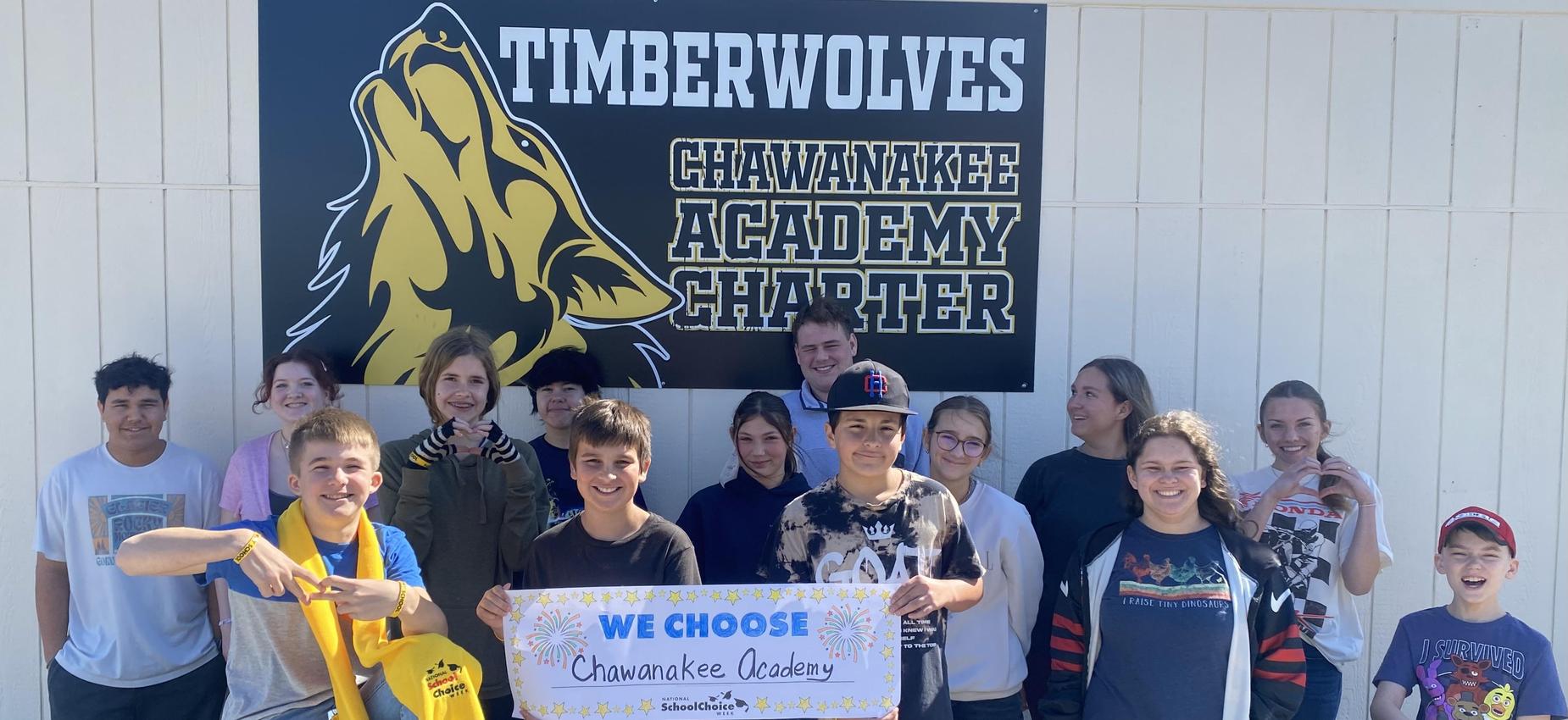 Group of students holding a sign that says 'We Choose Chawanakee Academy.'