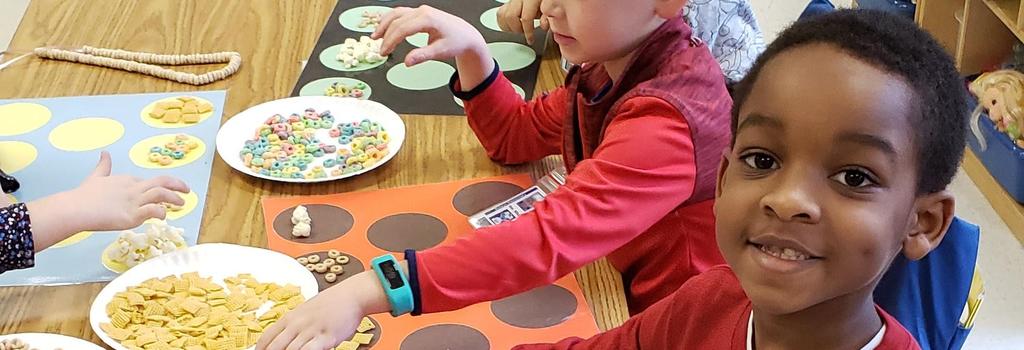 Kindergarten students counting cereal