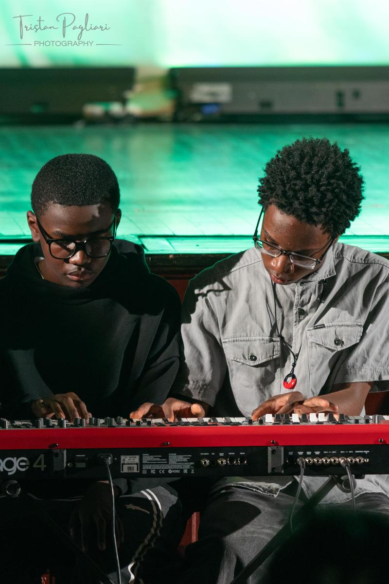 Two boys playing the piano