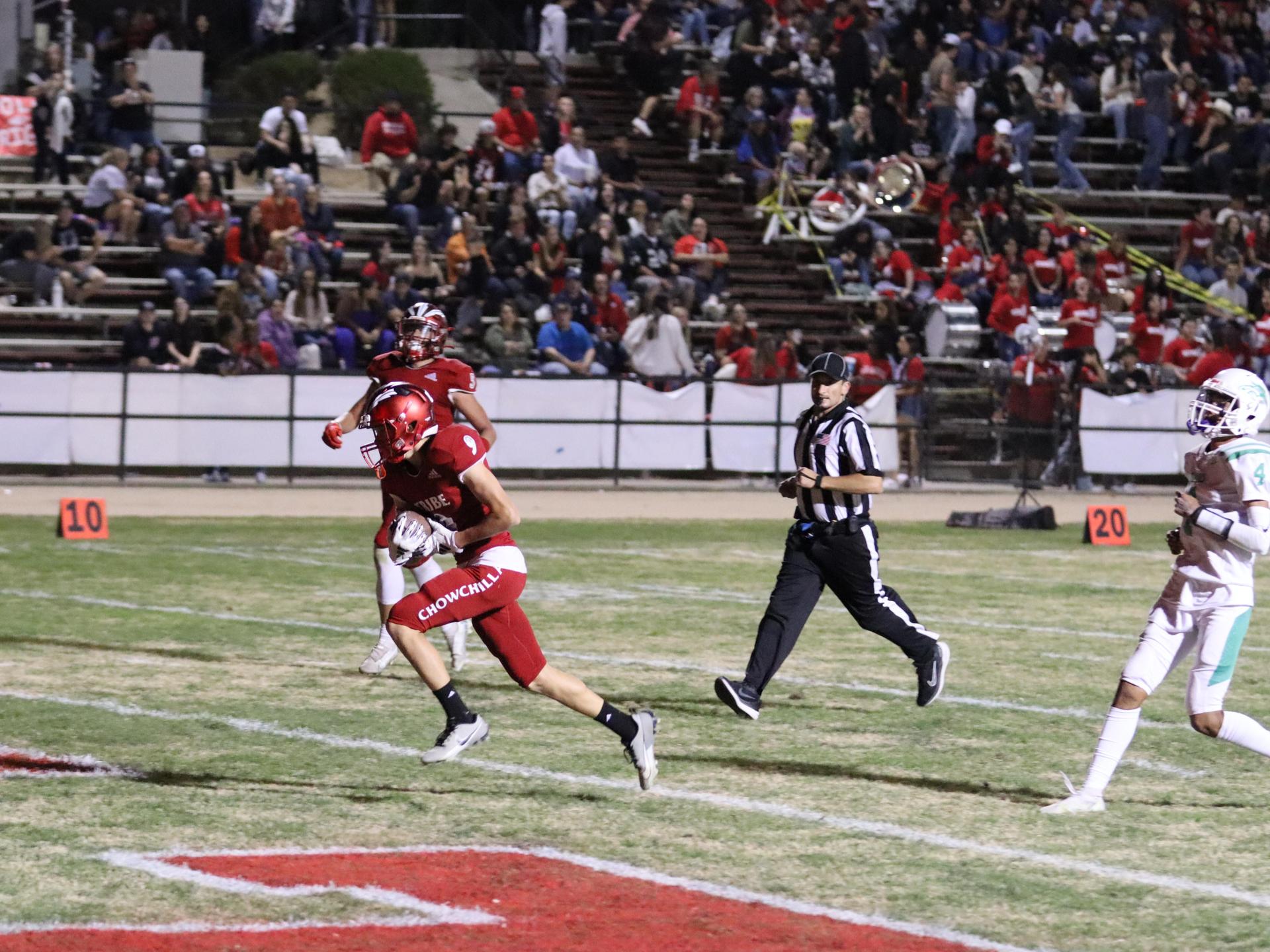 varsity football players in action against Riverdale