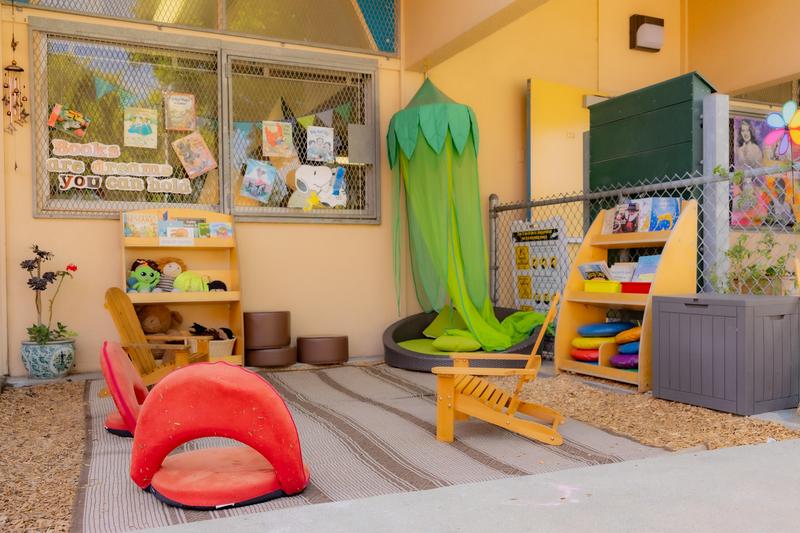 Outdoor classroom patio filled with seating and bookshelves