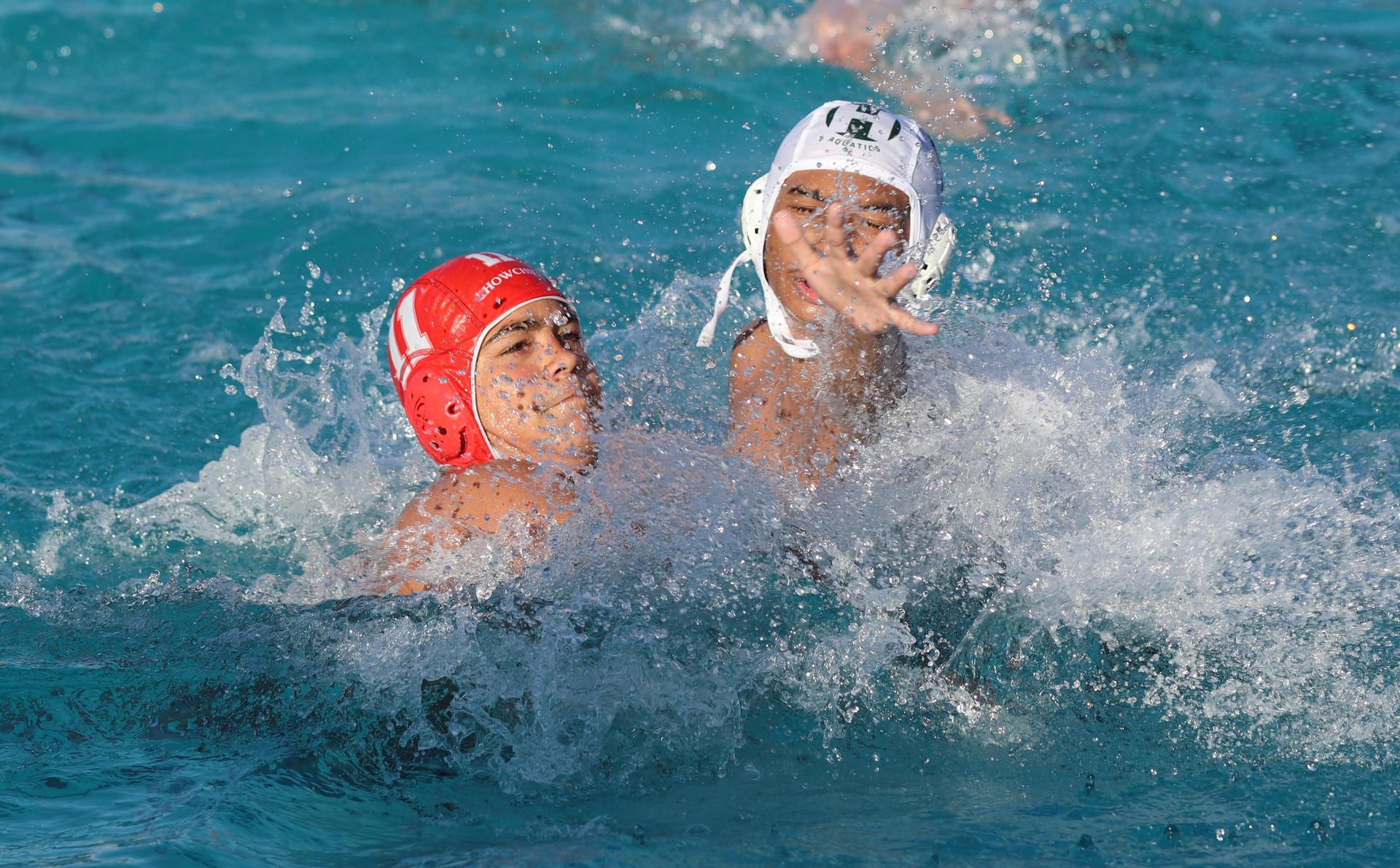 boys water polo players in action against hoover