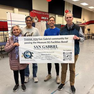4 current board members holding a Measure SG banner