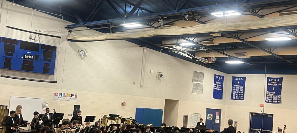teacher conducts student band
