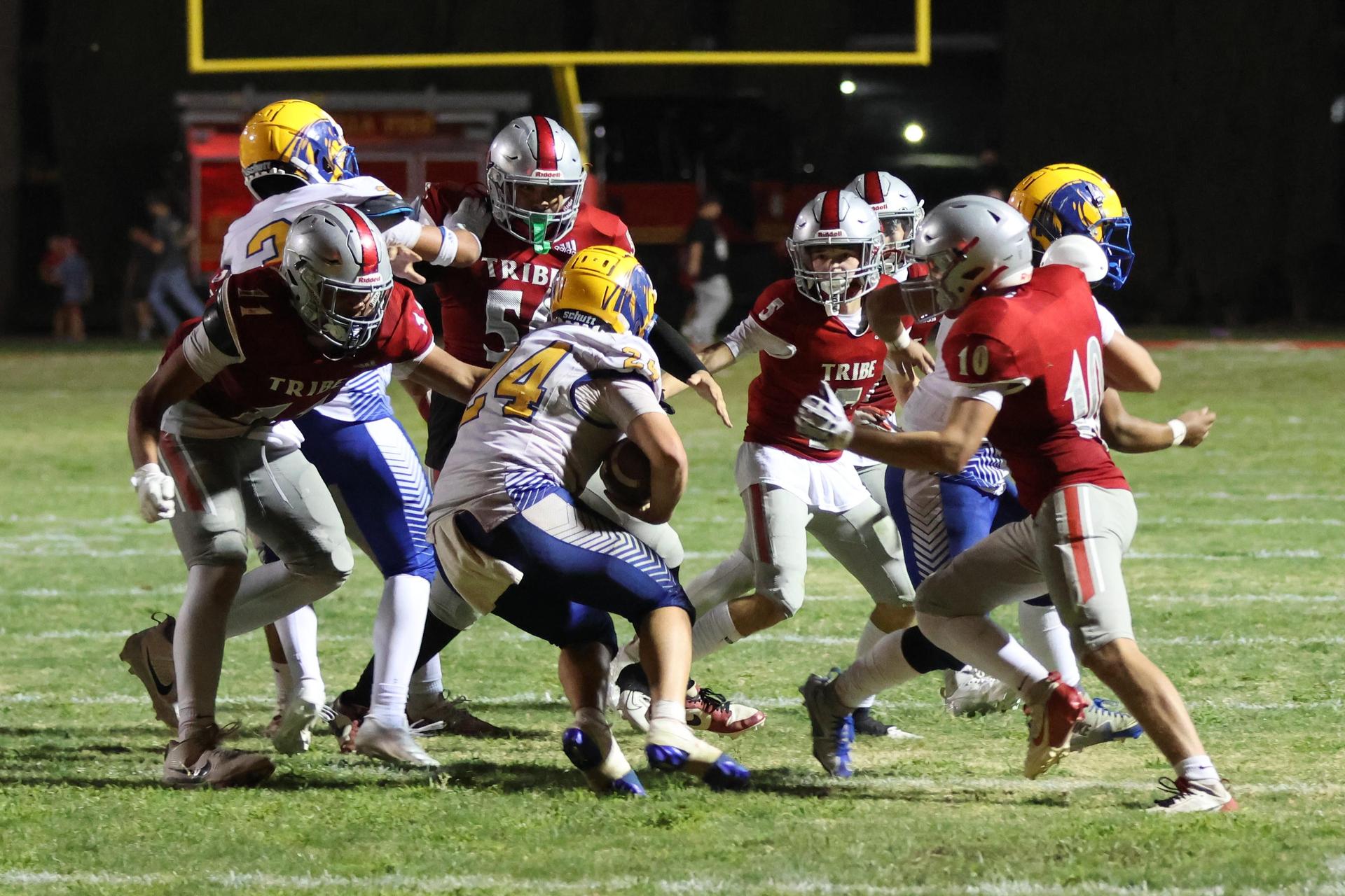 Varsity football players in action against Parlier 75