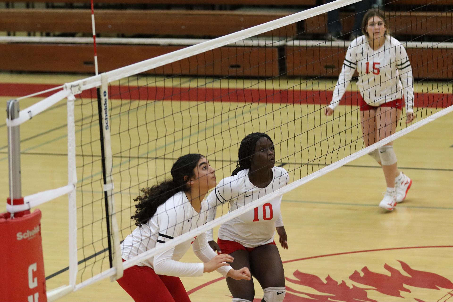 varsity volleyball players in action against liberty