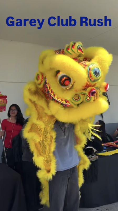 Student holds a puppet dragon from china