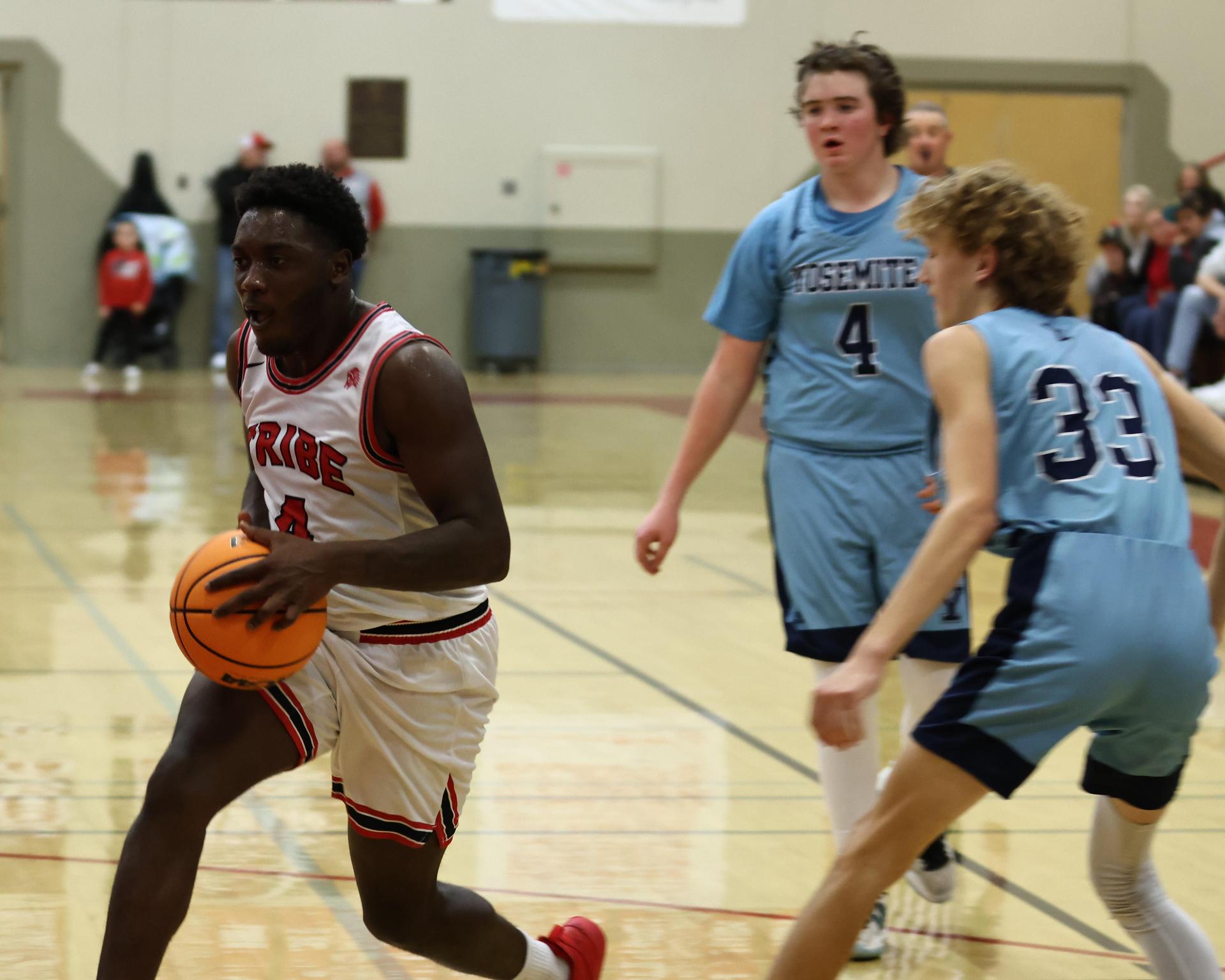 Varsity boys playing basketball against yosemite