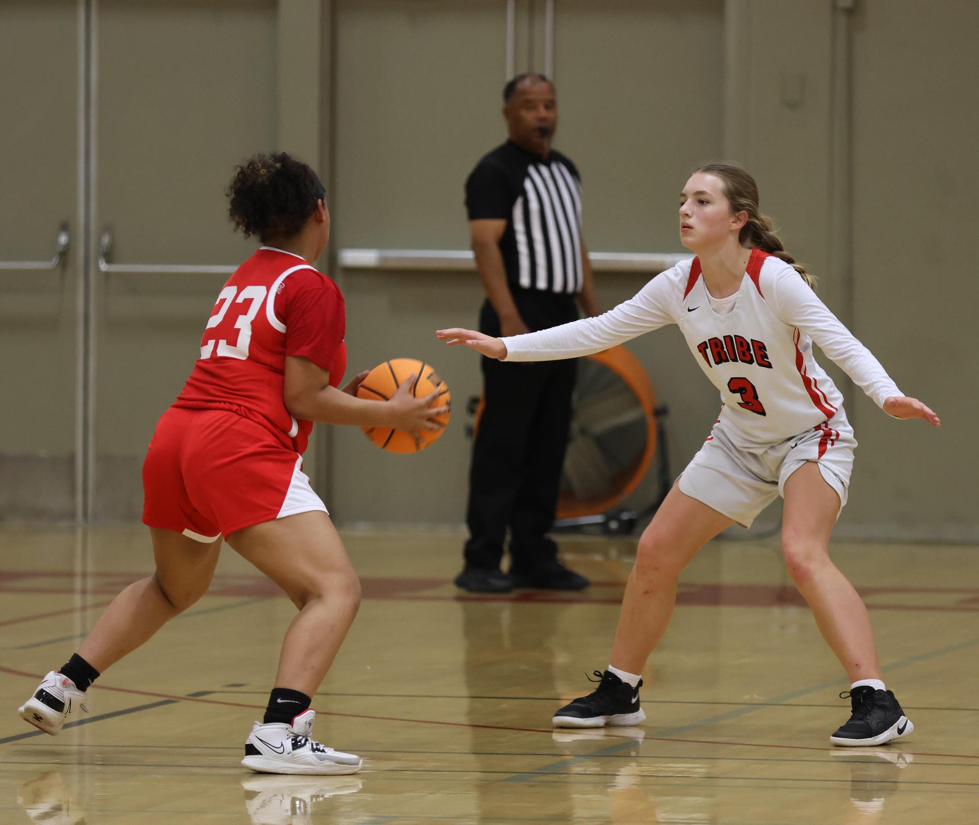 varsity girls playing basketball against mclane