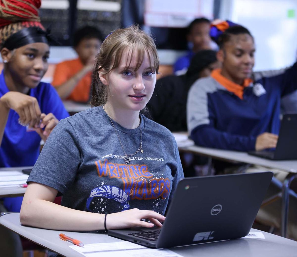 Horizon Science Academy Youngstown student wearing headphones uses a laptop in class
