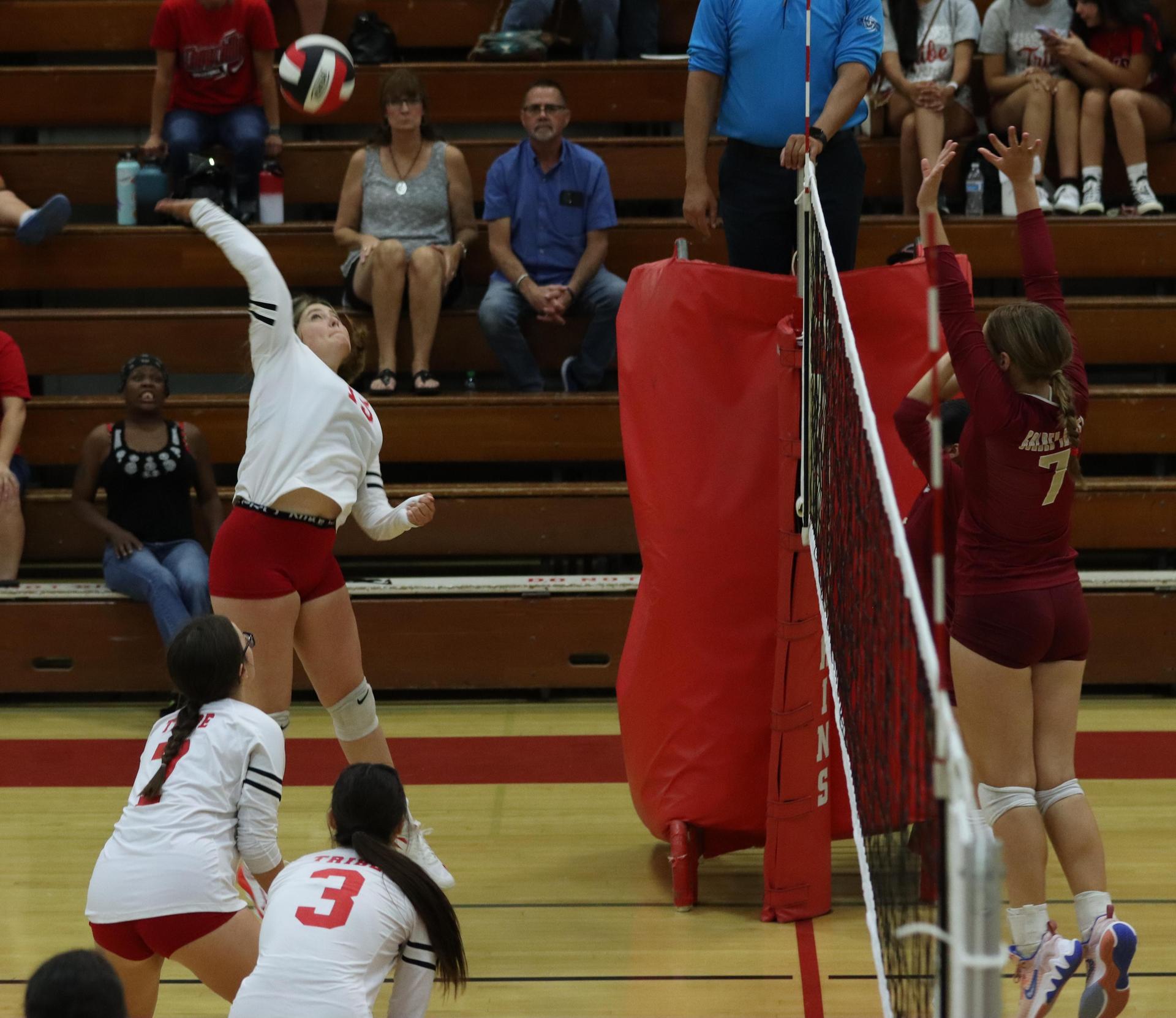 varsity volleyball players in action against golden valley
