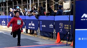 Another IS 145 running club member crossing the finish line.