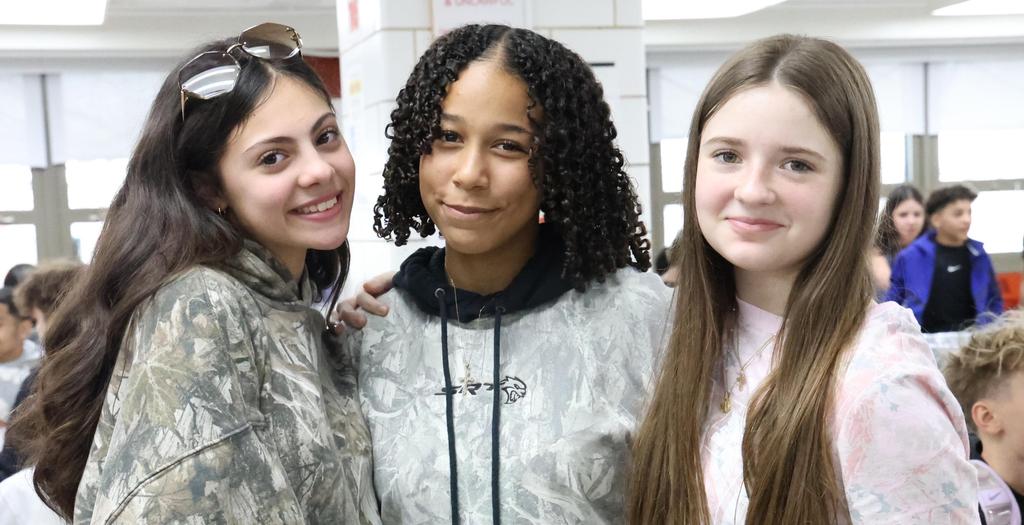 3 girls wearing camouflage shirts
