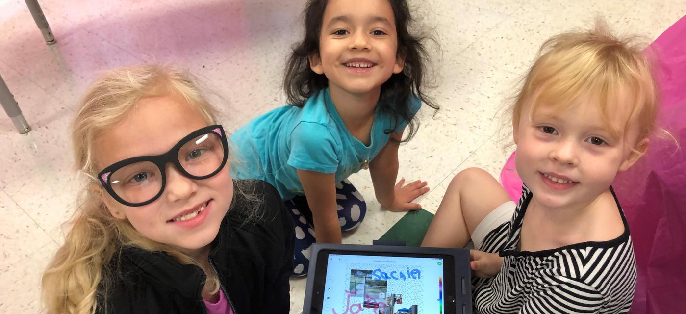 young students learning to write with the use of technology
